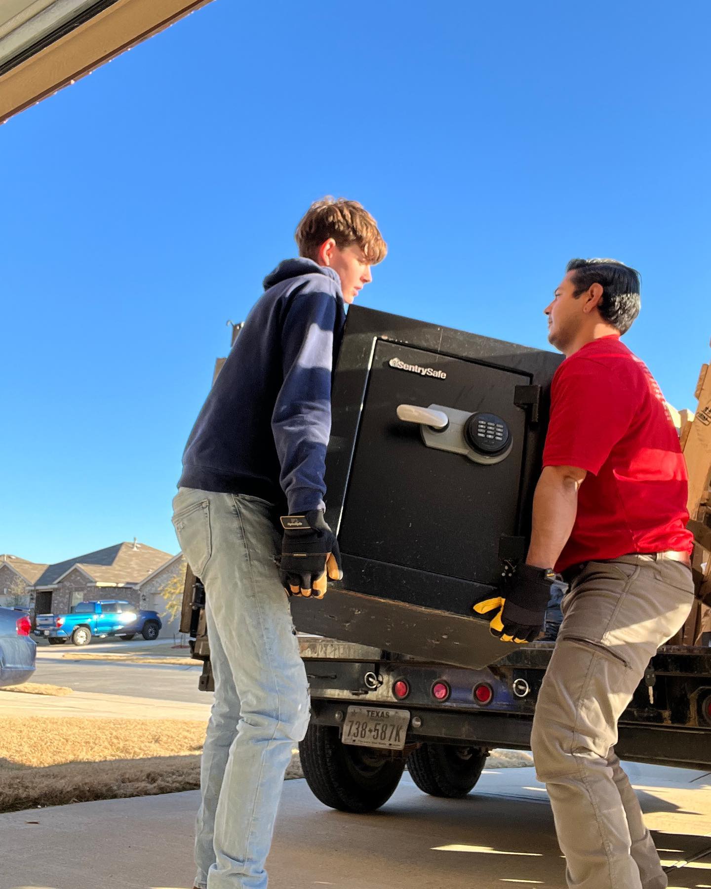 team members picking up a safe