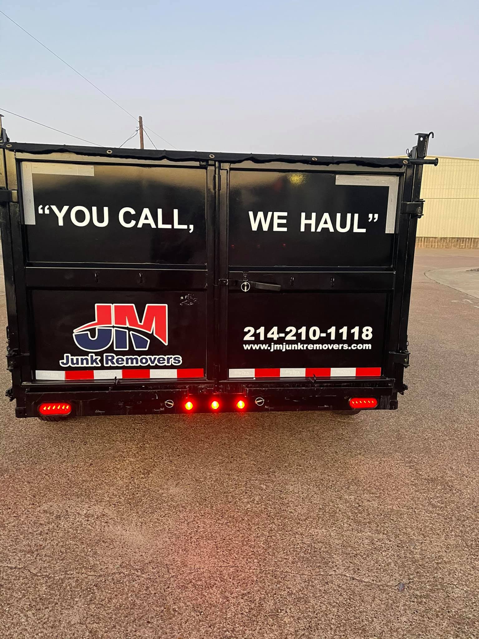 junk removal back of the trailer with logo and slogan