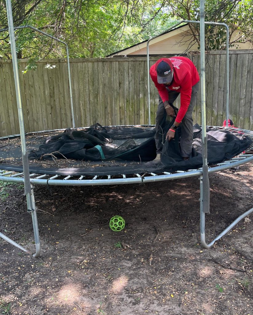 tearing off the sides of a trampoline to then haul it away