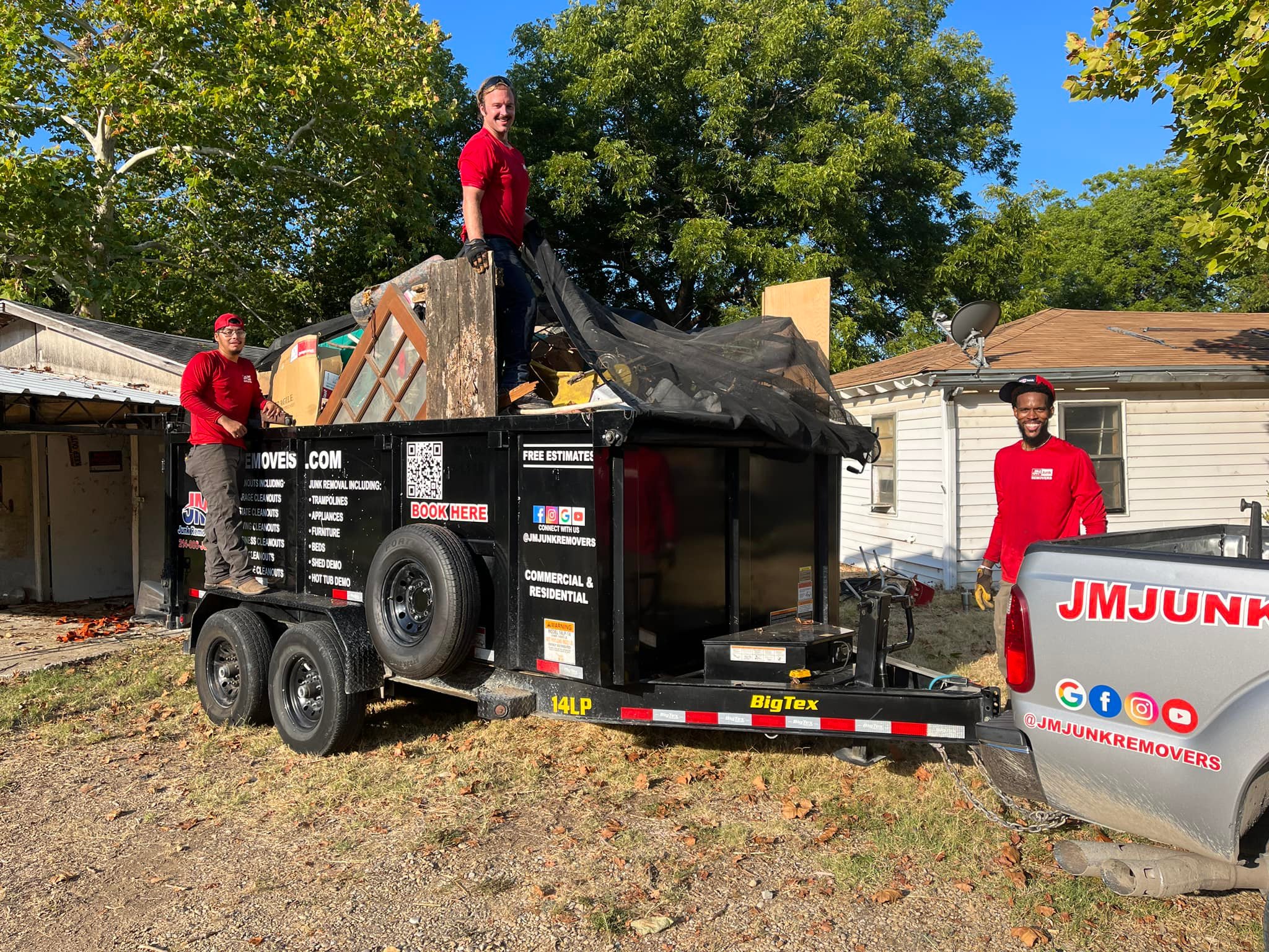 trailer full of junk with team members around it