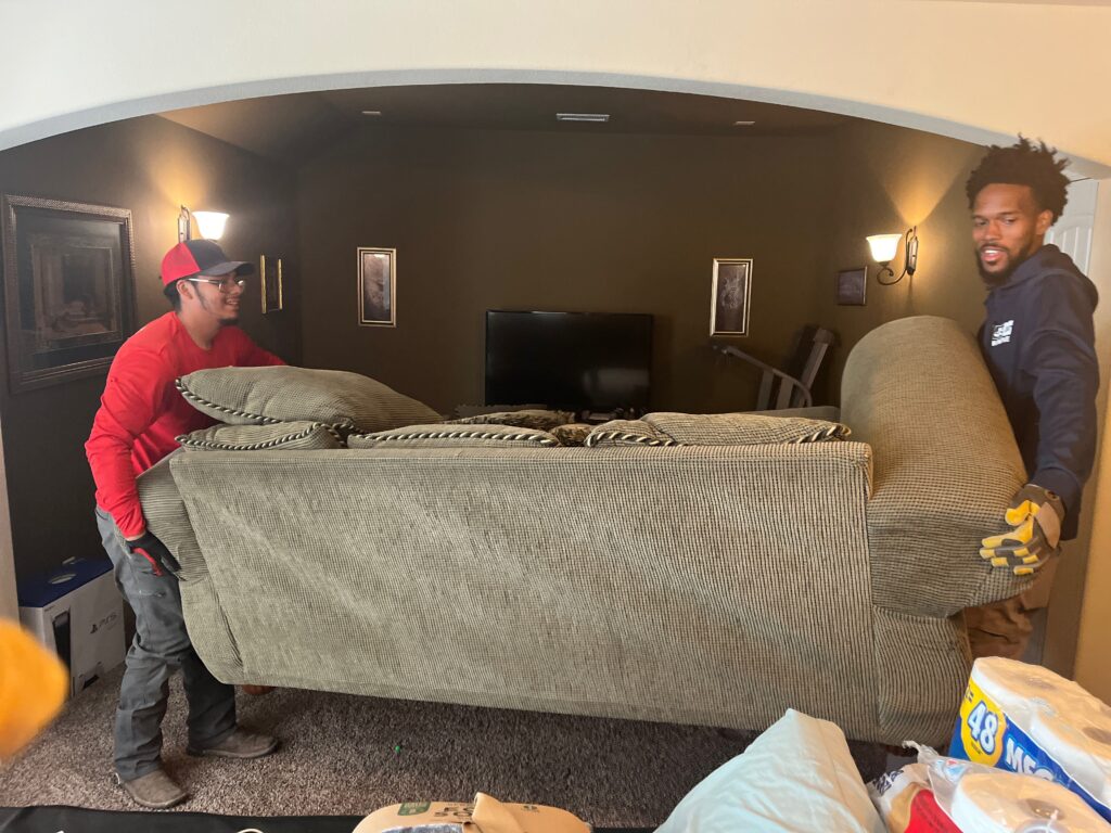 Two people removing furniture with gloves