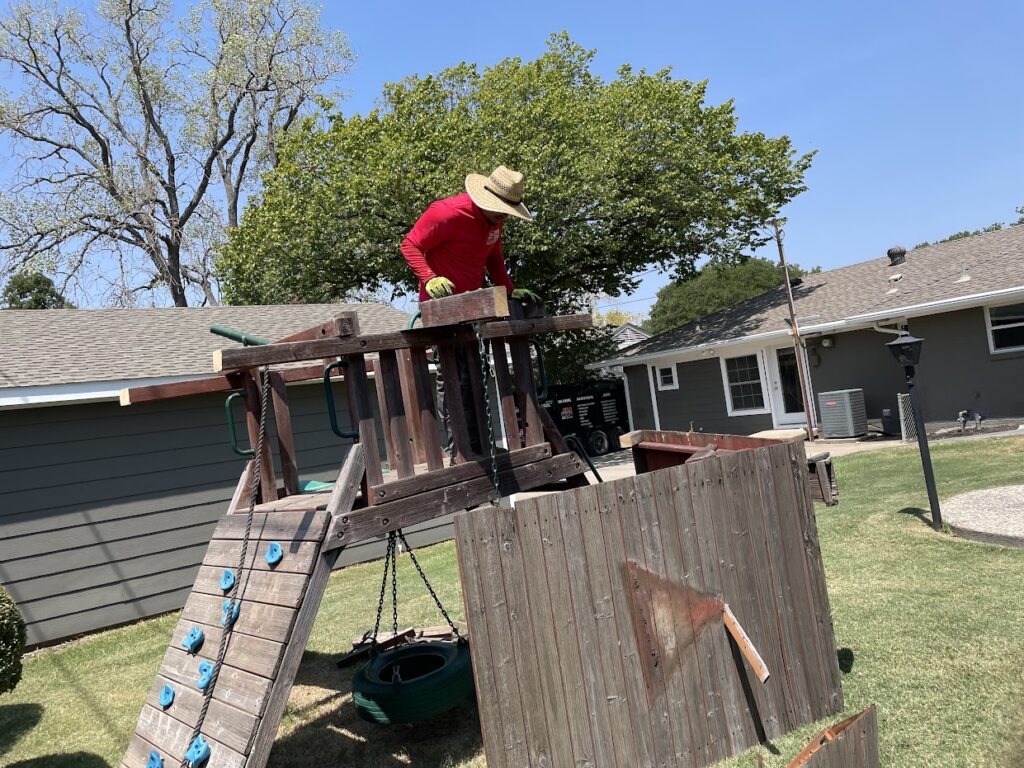 JM junk crew removing playset in lake highlands
