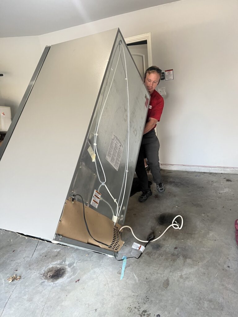 jm junk removers moving an old fridge appliance