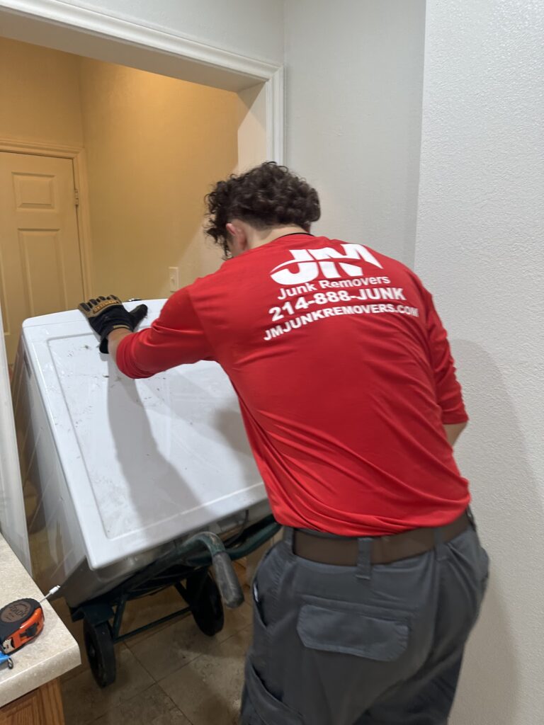 JM junk removers rolling out broken appliance in Plano, TX.