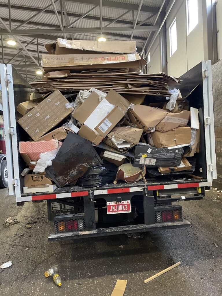 cardboard boxes loaded up into jm junk trailer