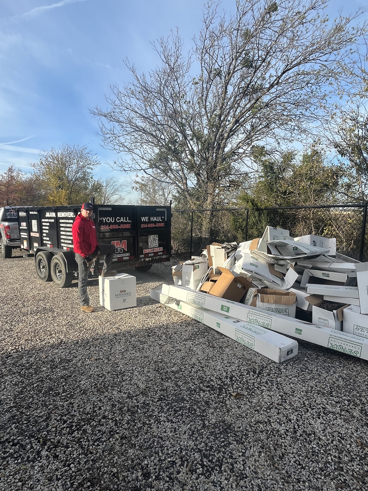 cardboard boxes being loaded into jm junk trailer