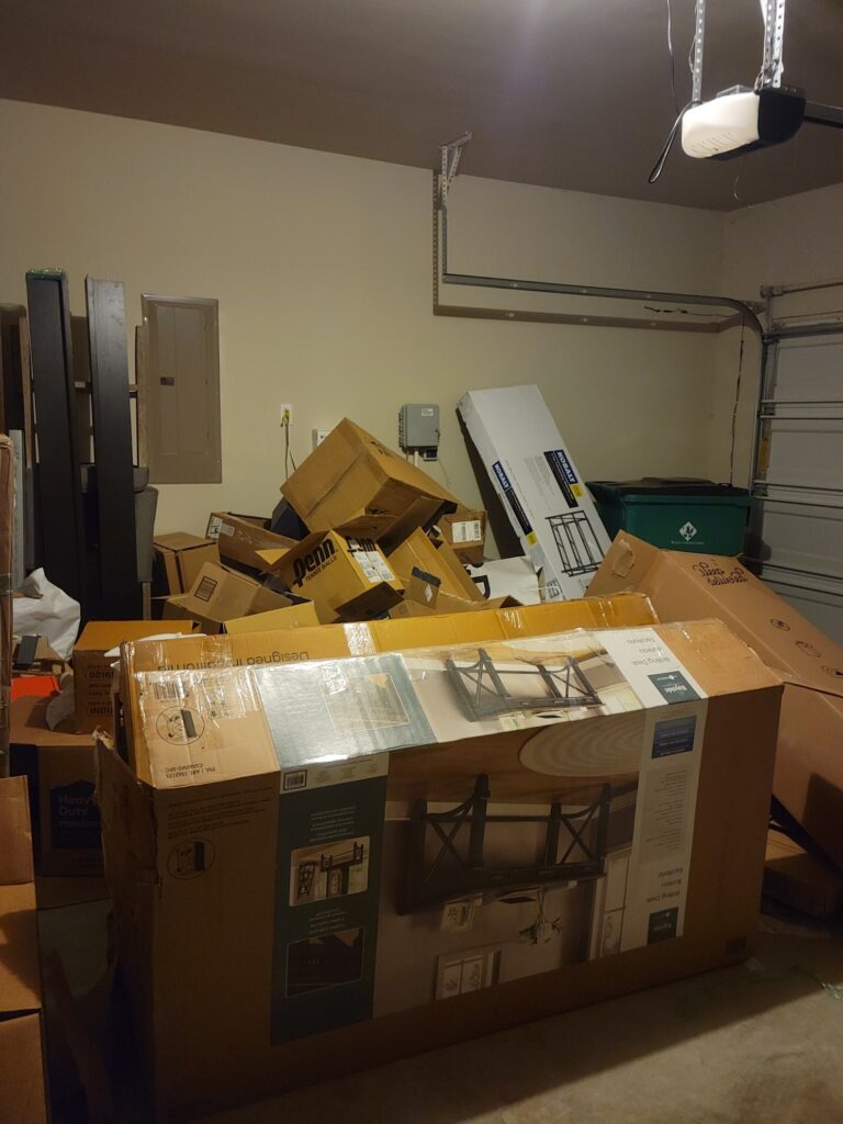 cardboard boxes crowded in garage needing removal