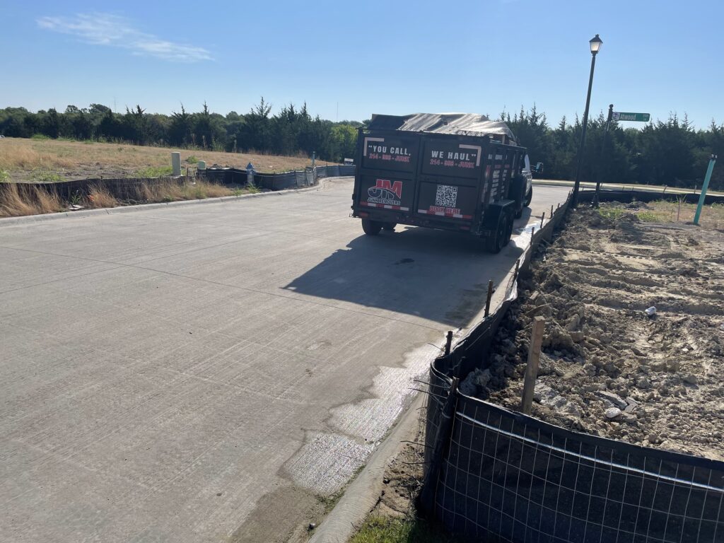 jm junk hauling off cardboard boxes in trailer