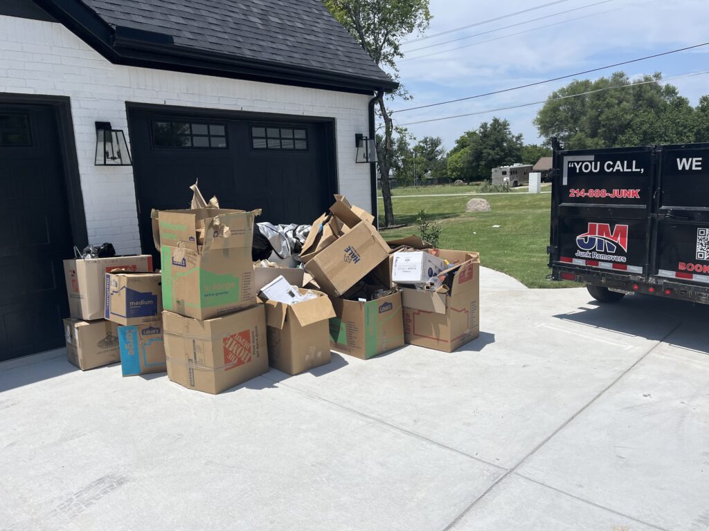 jm junk loading cardboard boxes into trailer