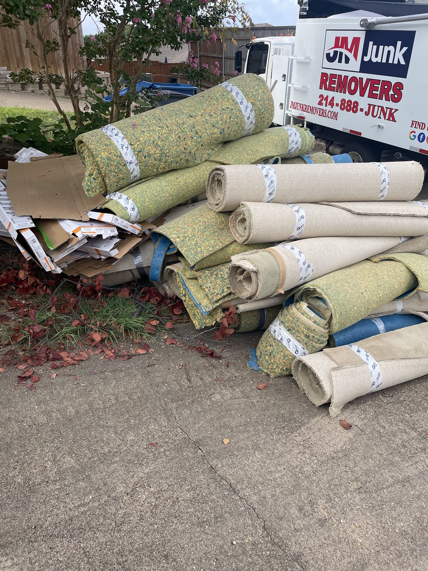 jm junk loading carpet into truck