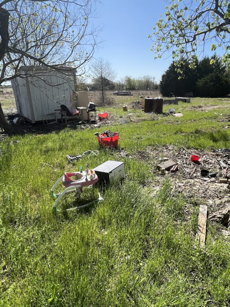 yard covered in illegal dumping