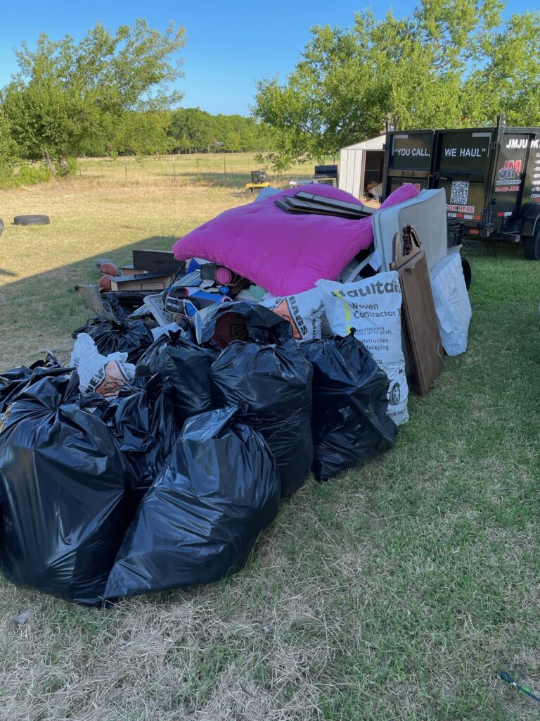 bagged yard waste being picked up by jm junk removers