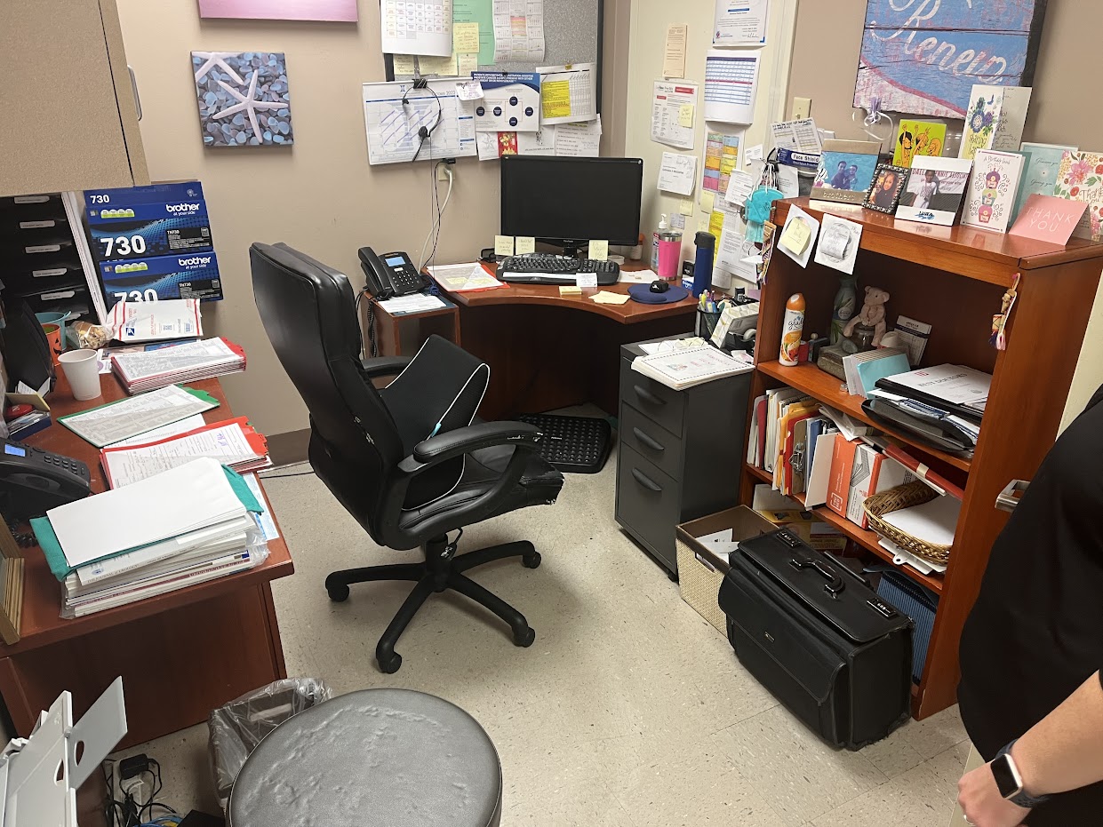 Cluttered office workspace needing commercial office cleanout.