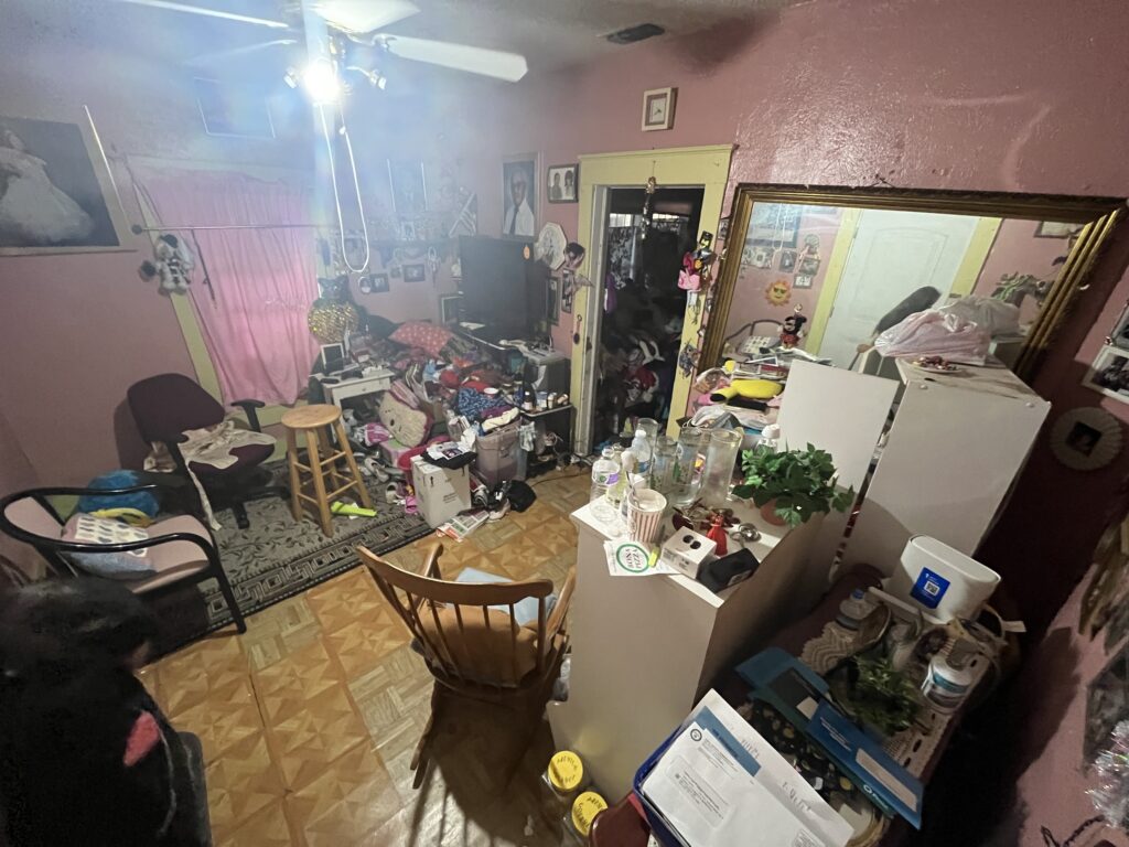 bedroom overrun with clutter needing a hoarder cleanout