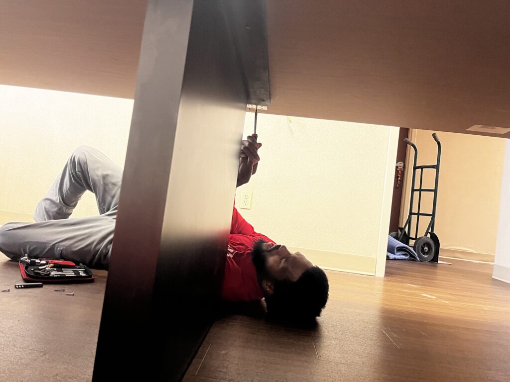 jm junk crew dismantling desk in office cleanout