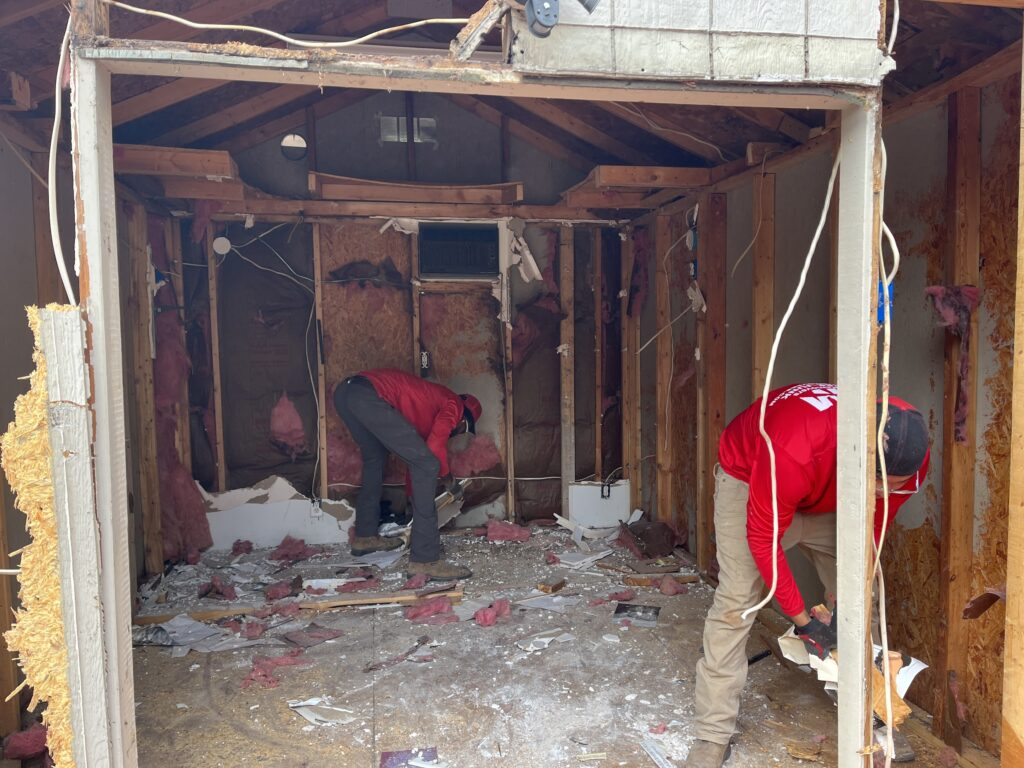 jm junk removers demolishing a shed