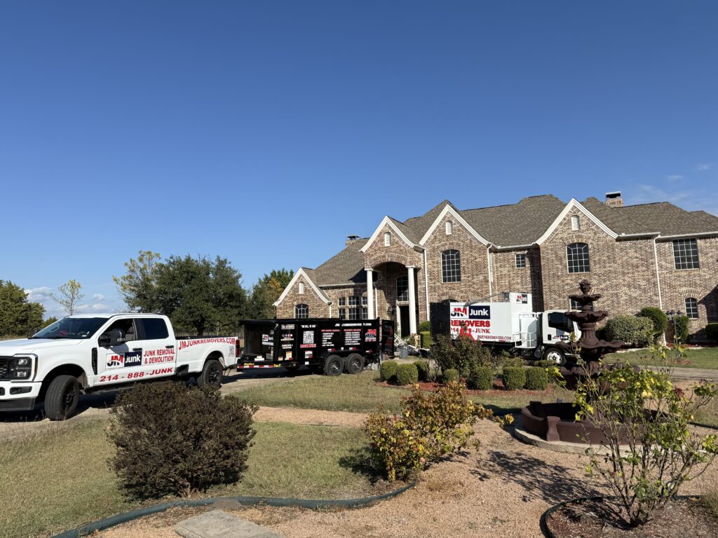 JM Junk Removers Trucks sitting in front of an estate for a cleanout job.